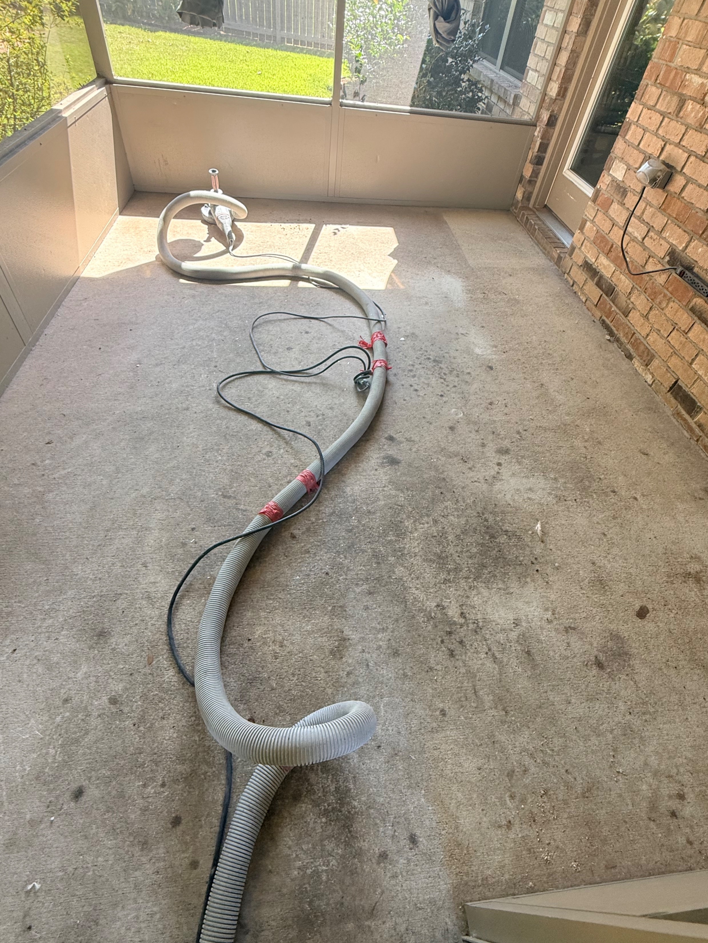 Before — bare stained concrete sunroom floor
